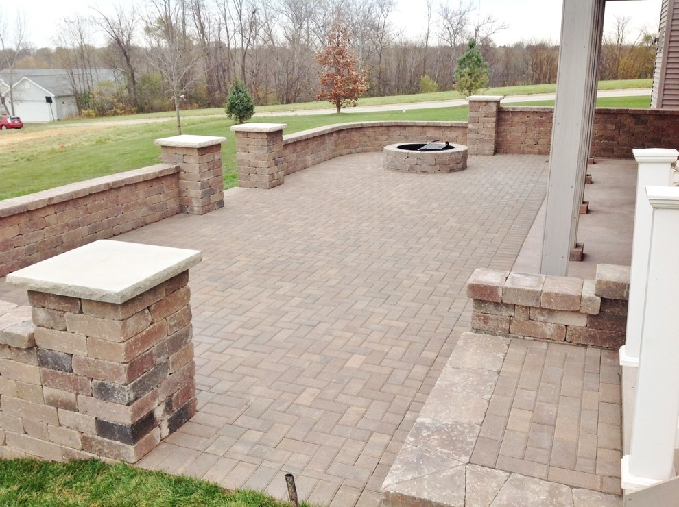 Inspiration for a large timeless backyard brick patio remodel in Chicago with a fire pit