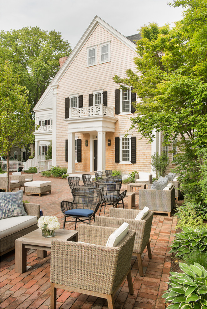 Inspiration for a large coastal brick patio remodel in Boston with no cover