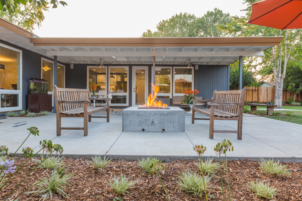 Trendy backyard concrete patio photo in San Francisco with a fire pit and no cover