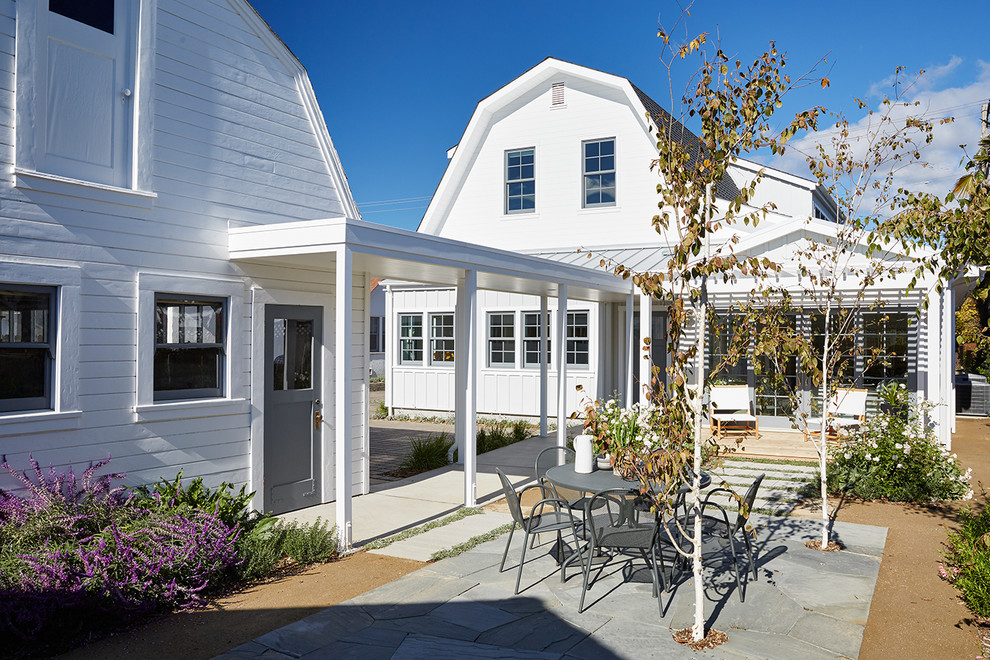 Example of a mid-sized cottage backyard decomposed granite patio design in San Francisco with a pergola