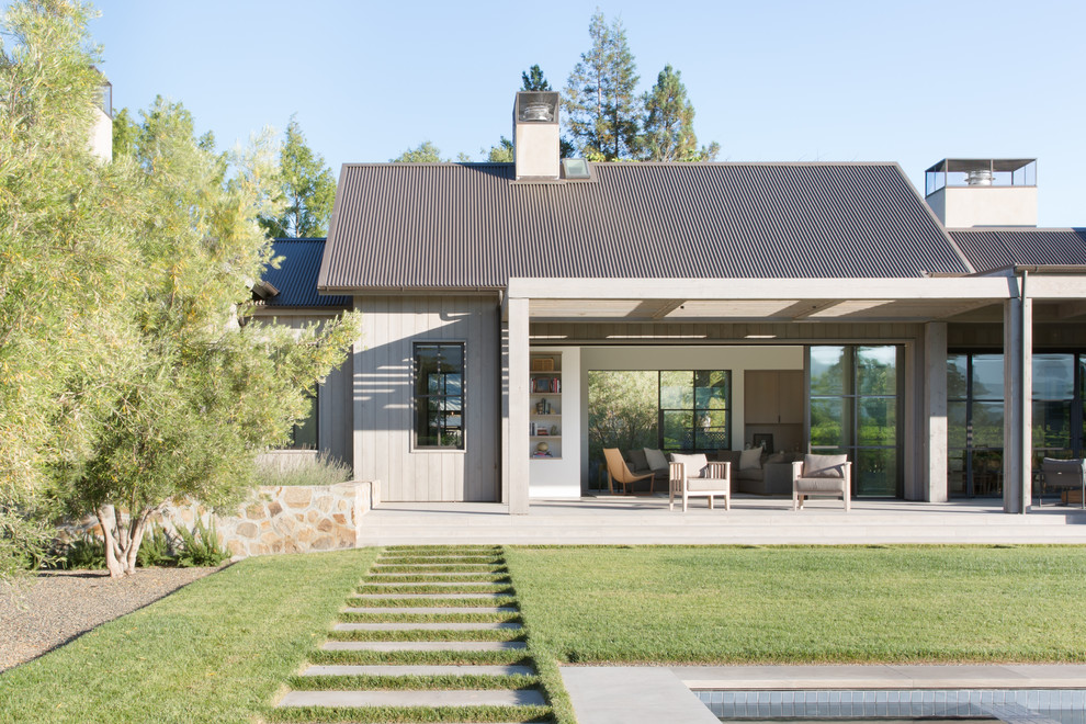 Inspiration for a farmhouse back patio in San Francisco with concrete slabs and a pergola.