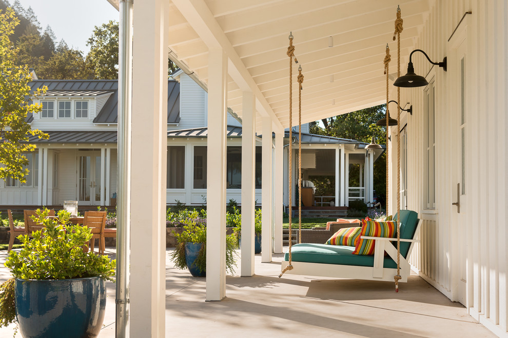 Farmhouse patio in San Francisco with concrete slabs and a roof extension.