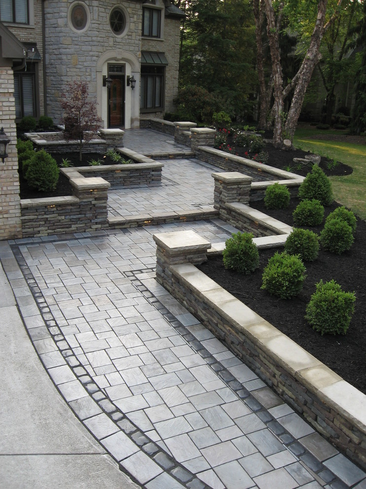 Expansive front patio in Columbus with a water feature and concrete paving.