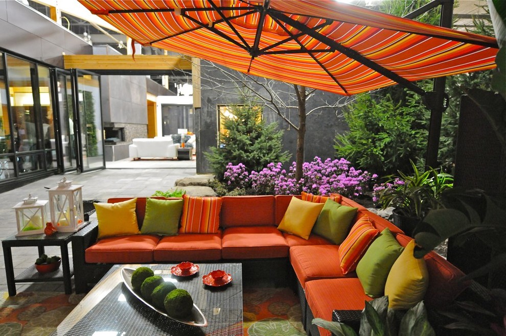 Example of an island style patio design in Toronto