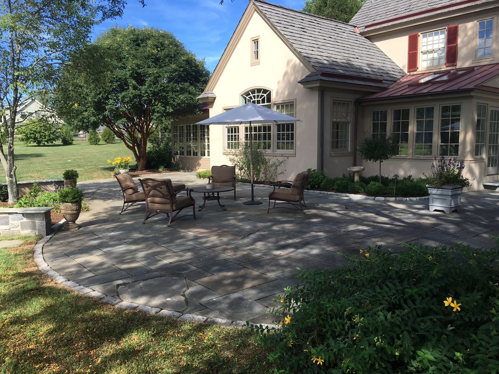 Inspiration for a large timeless backyard stone patio remodel in Philadelphia with no cover
