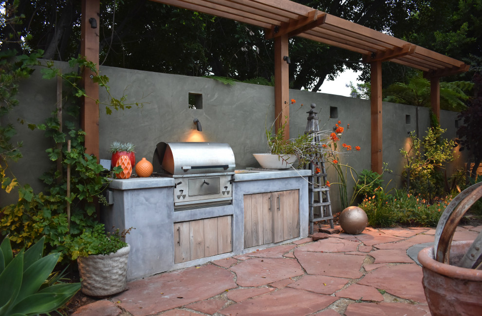 Design ideas for a large bohemian back patio in Los Angeles with natural stone paving, an outdoor kitchen and no cover.