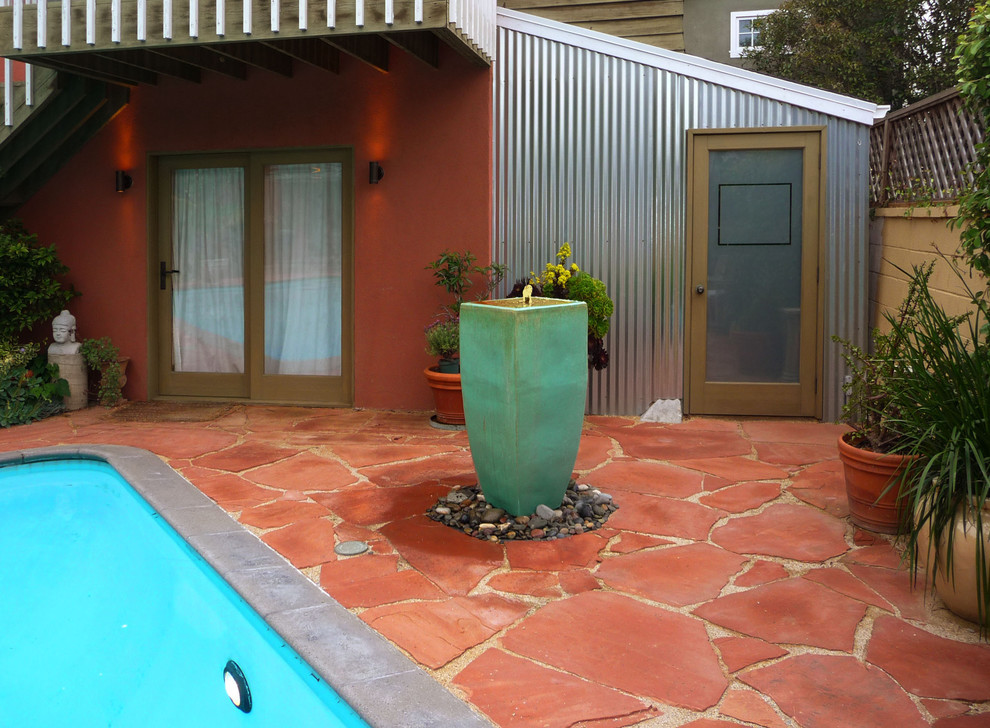 Patio kitchen - large mediterranean backyard stone patio kitchen idea in Los Angeles with no cover