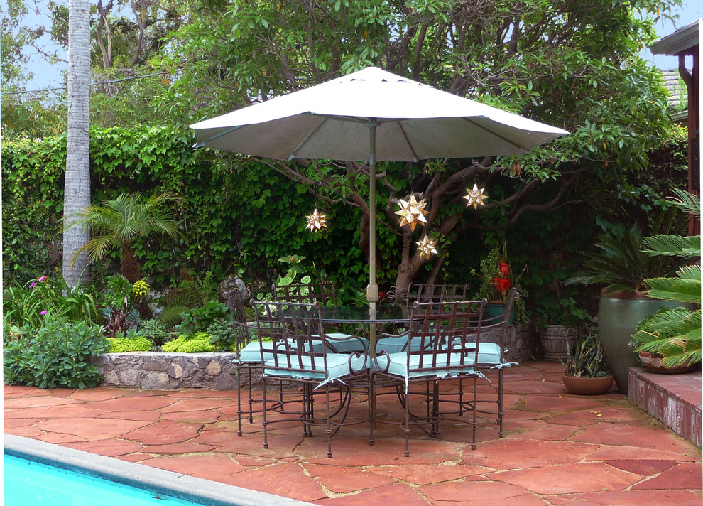 Inspiration for a large mediterranean backyard stone patio kitchen remodel in Los Angeles with no cover