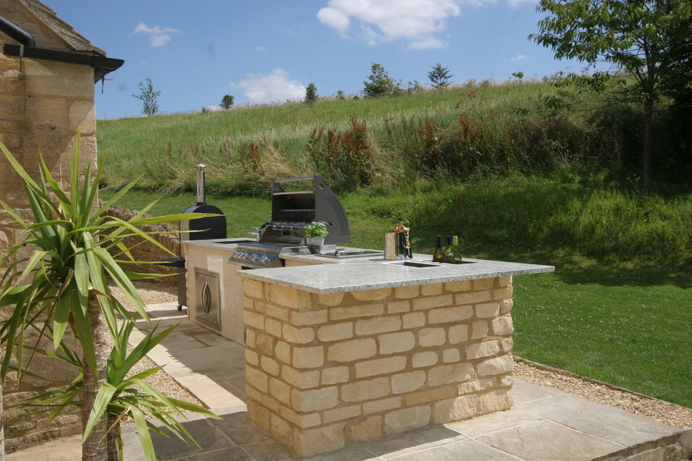 Medium sized country back patio in Wiltshire with an outdoor kitchen and no cover.