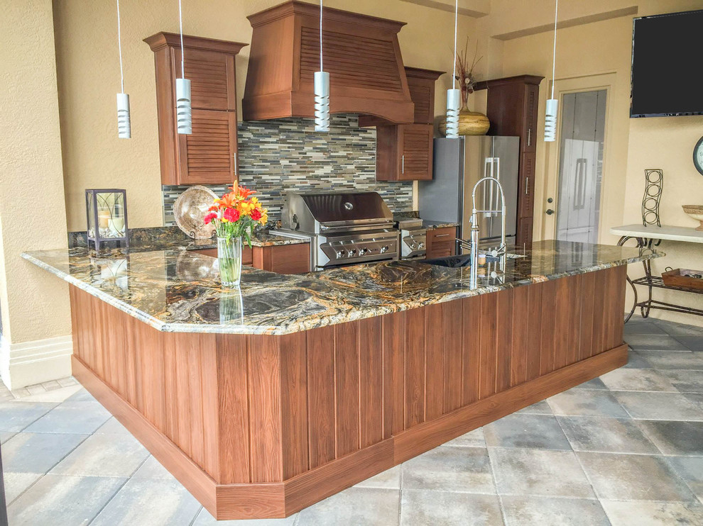 Inspiration for a large contemporary u-shaped concrete floor open concept kitchen remodel with a farmhouse sink, louvered cabinets, medium tone wood cabinets, granite countertops, multicolored backsplash, glass tile backsplash, stainless steel appliances and a peninsula