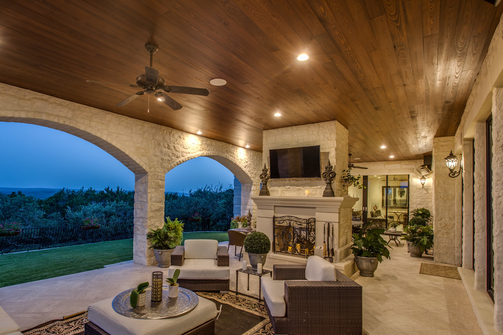 Inspiration for a huge transitional backyard tile patio remodel in Austin with a roof extension