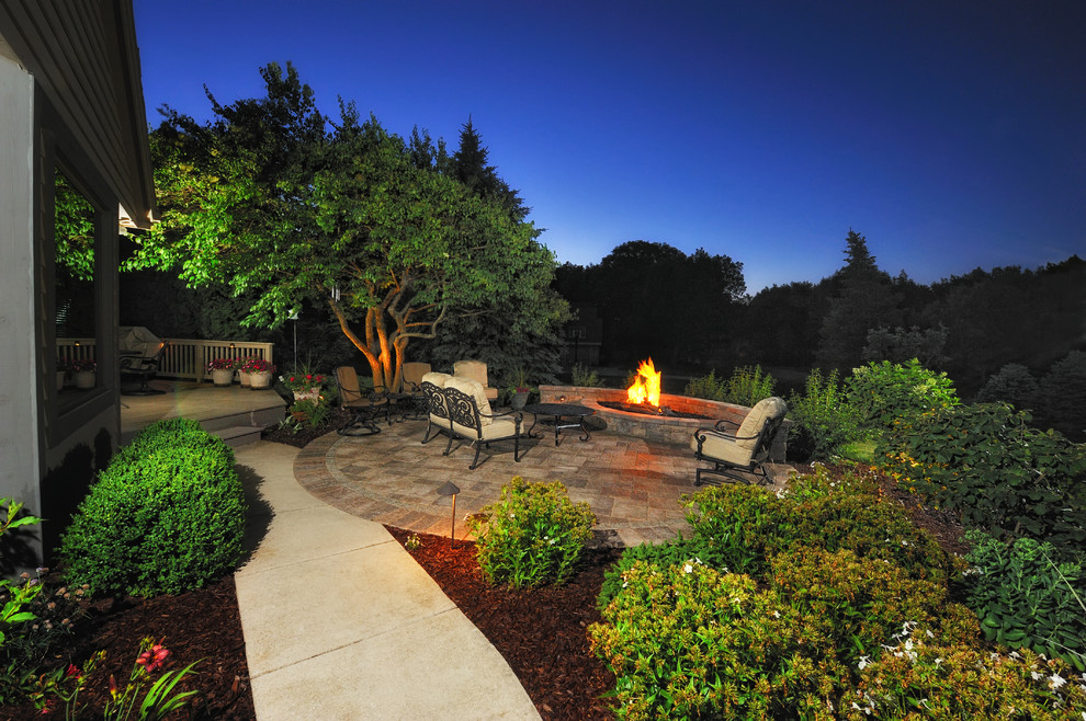 Patio - mid-sized traditional backyard concrete paver patio idea in Milwaukee with a fire pit and no cover