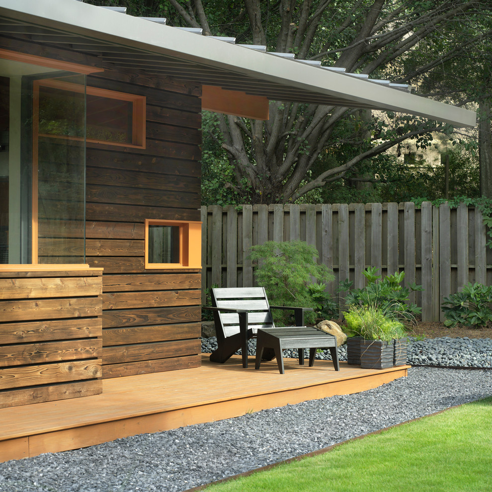 Design ideas for a small contemporary back patio in San Francisco with decking, a roof extension and fencing.