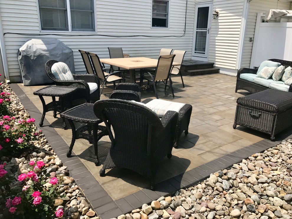 Mid-sized transitional backyard concrete paver patio photo in Philadelphia with no cover