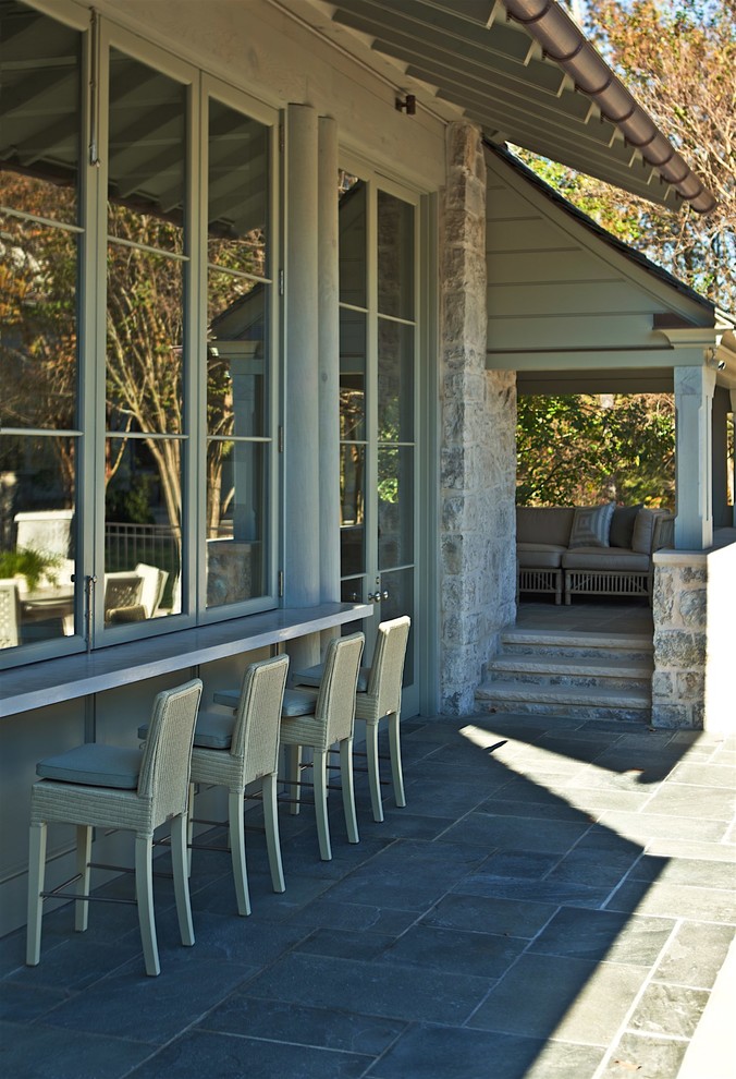 Inspiration for a mid-sized timeless backyard stone patio kitchen remodel in Charlotte with a roof extension
