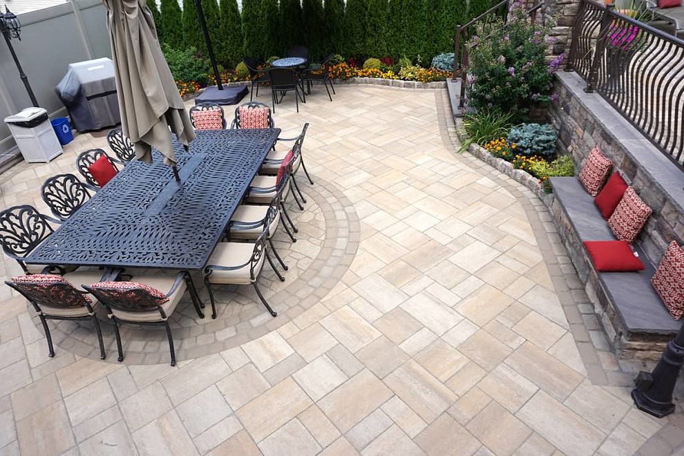 Inspiration for a medium sized classic back patio in New York with an outdoor kitchen, natural stone paving and no cover.