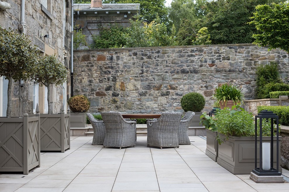 Elegant backyard tile patio photo in Other with no cover