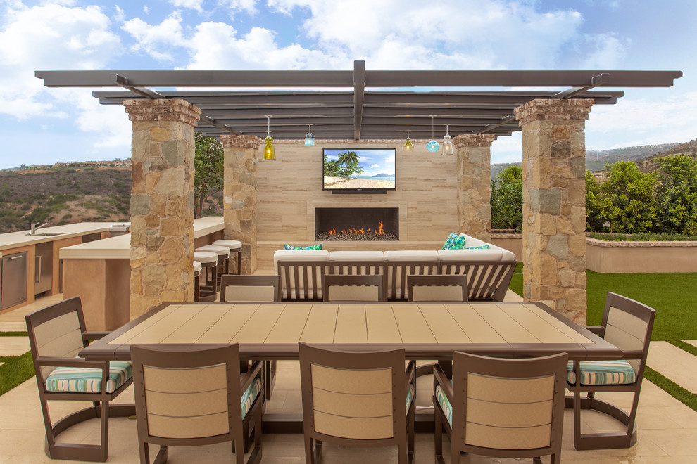 Design ideas for a mediterranean back patio in Orange County with a pergola and a bar area.