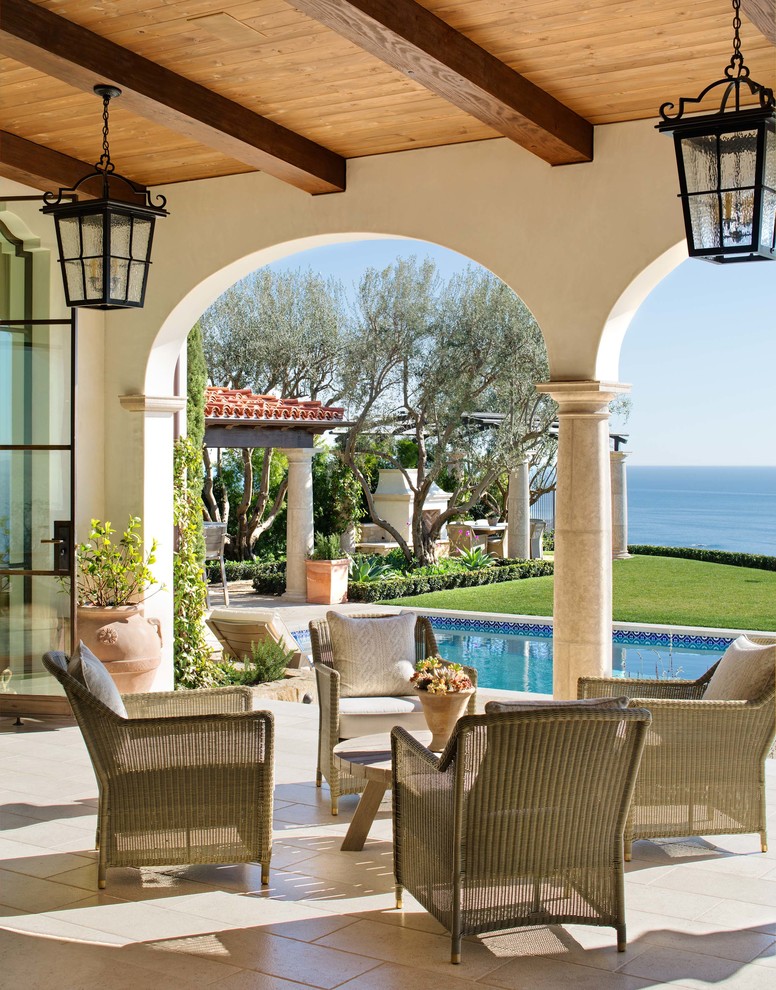 Design ideas for a mediterranean patio in Orange County with a roof extension.