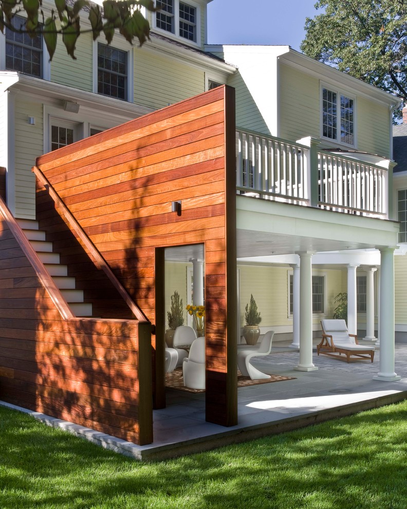 Inspiration for a large contemporary backyard stone patio remodel in Boston with a roof extension
