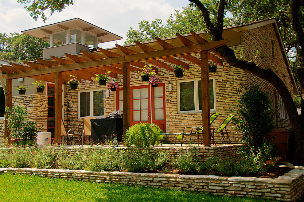 This is an example of a contemporary back patio in Austin with a pergola.