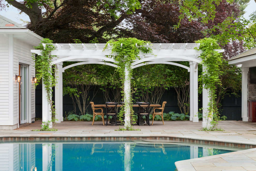 Inspiration for a timeless backyard stone patio remodel in Boston with a pergola