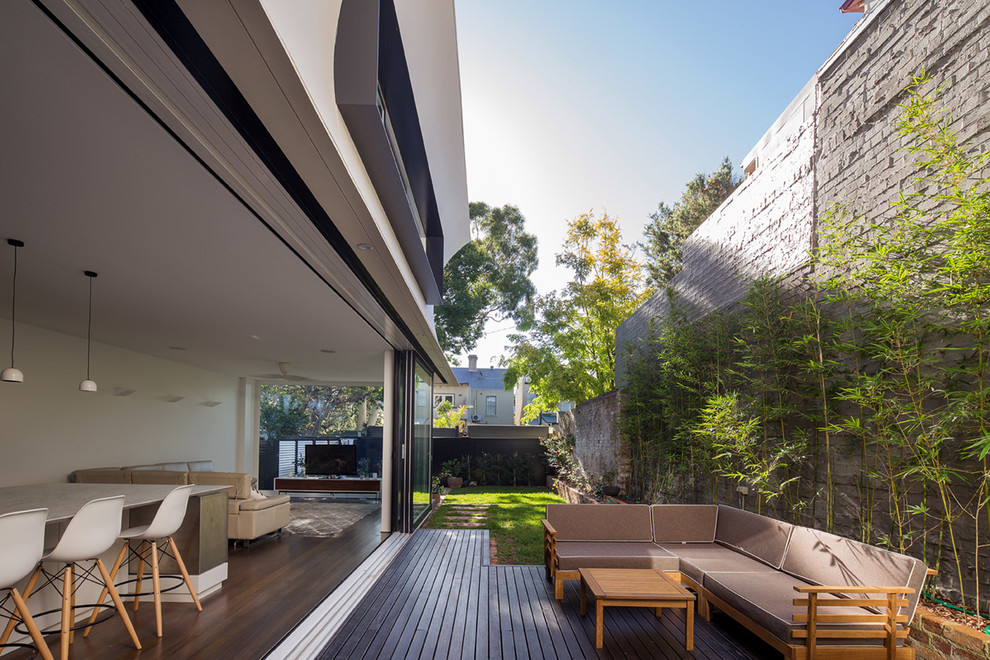 Inspiration for a mid-sized contemporary backyard patio remodel in Sydney with decking and no cover