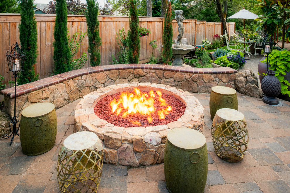 Inspiration for a medium sized mediterranean back patio in Portland with a fire feature, concrete paving and no cover.