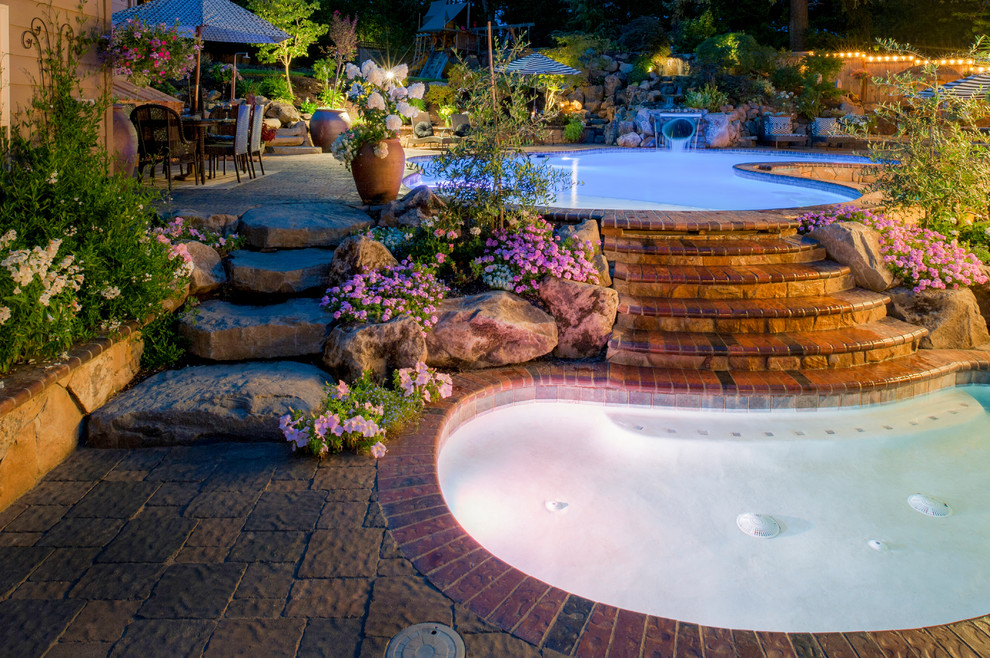 Large tuscan backyard concrete paver patio photo in Portland with no cover