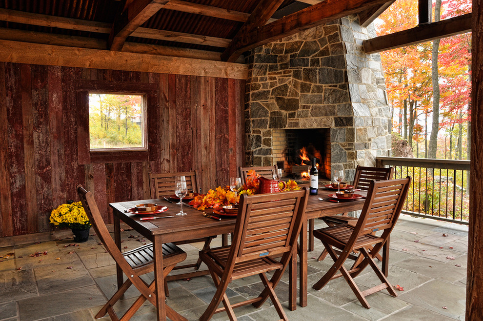 Rustic patio in Baltimore with a roof extension and a fireplace.