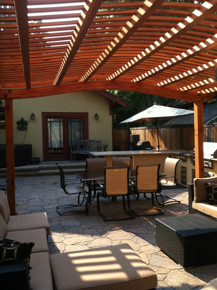 Inspiration for a mid-sized timeless backyard brick patio kitchen remodel in Boise with a pergola