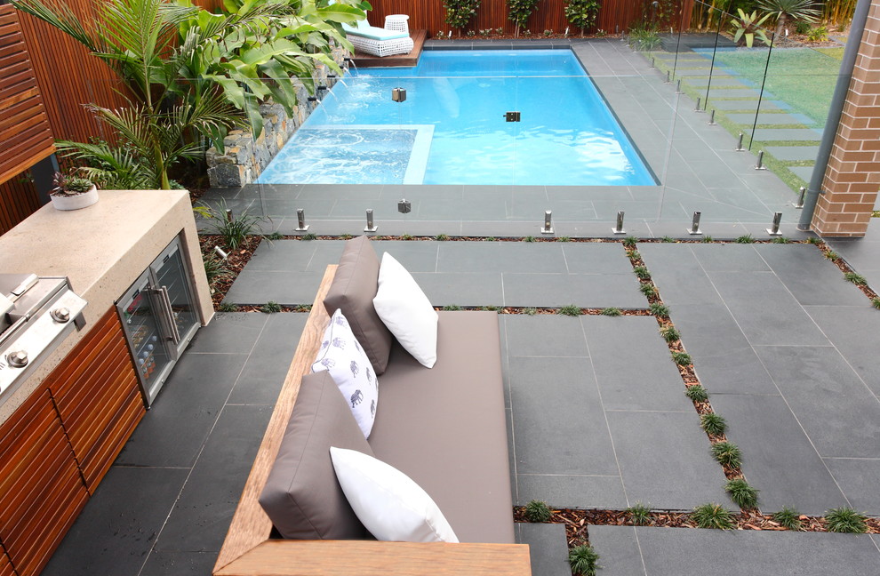 Patio kitchen - mid-sized transitional backyard stone patio kitchen idea in Sydney with a pergola