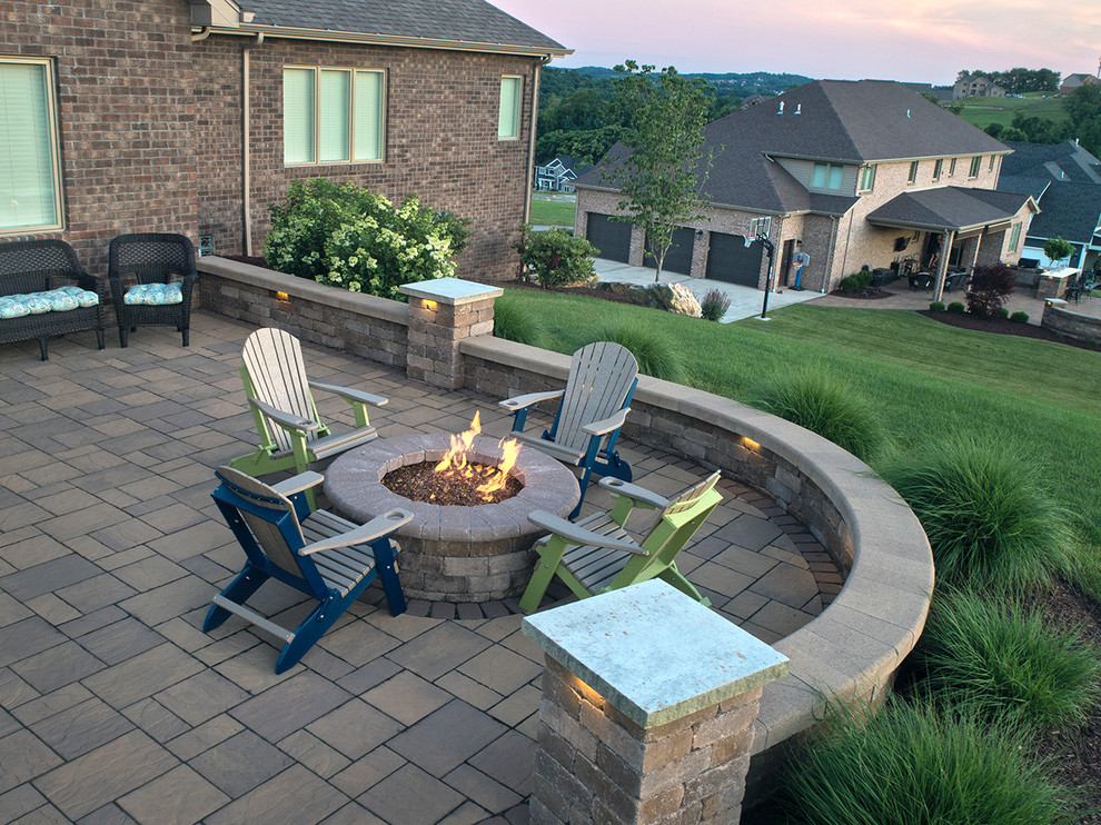 Example of a mid-sized trendy backyard brick patio design in Other with a fire pit and a gazebo