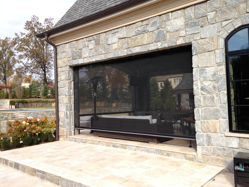 Inspiration for a mid-sized timeless backyard stone patio kitchen remodel in New York with a roof extension