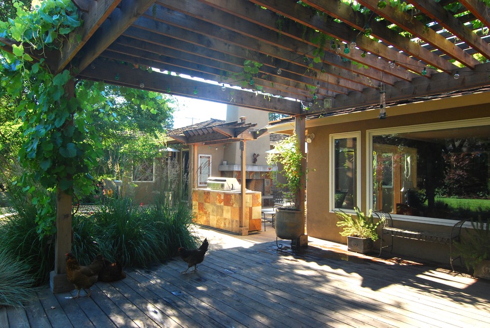 Mid-sized tuscan backyard patio container garden photo in San Francisco with decking and a pergola