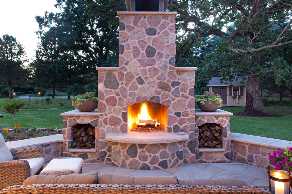 This is an example of a large country back patio in Minneapolis with a fire feature and no cover.