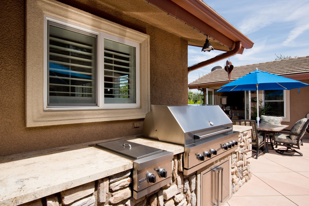 Large modern back patio in Los Angeles with an outdoor kitchen, concrete slabs and no cover.