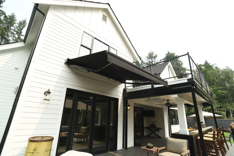 Country back patio in Seattle with an outdoor kitchen and an awning.