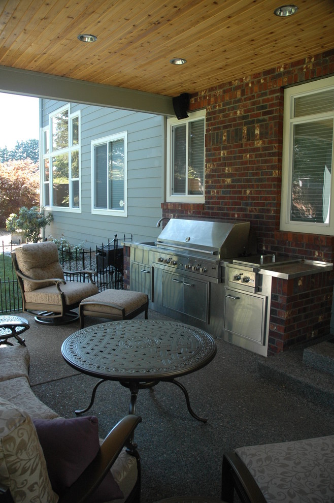 Photo of a medium sized classic front patio in Portland with an outdoor kitchen, concrete slabs and a roof extension.