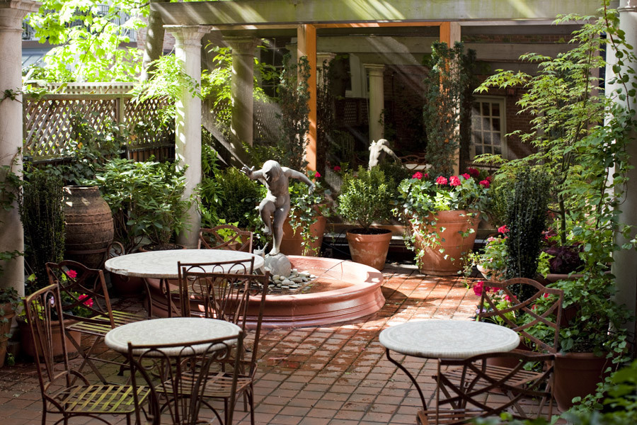 Design ideas for a traditional back patio in New York with a potted garden and tiled flooring.