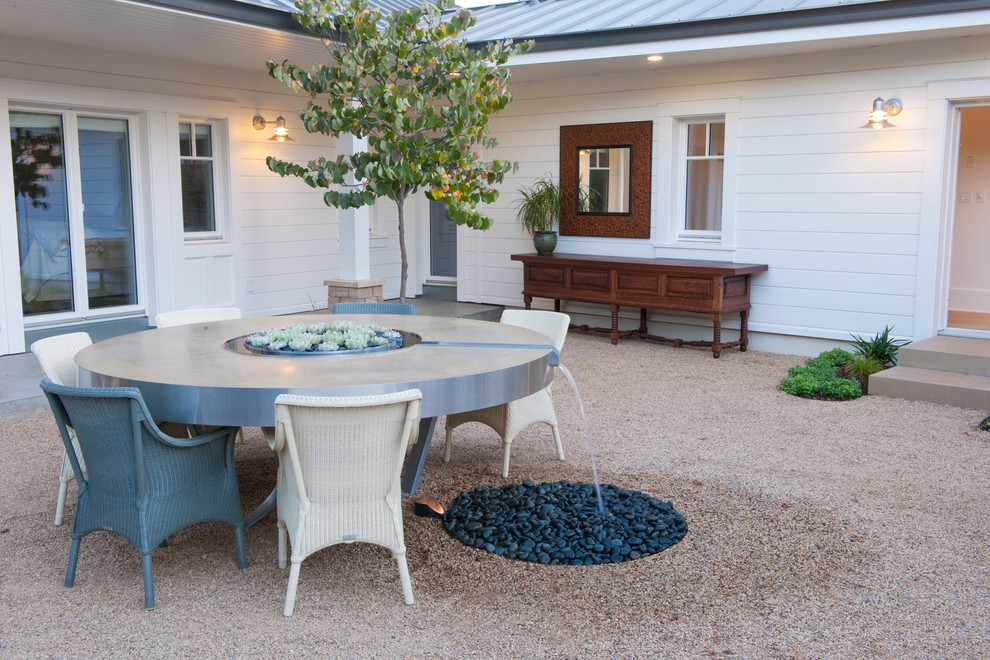 Design ideas for a large rural courtyard patio in San Francisco with a water feature, gravel and no cover.