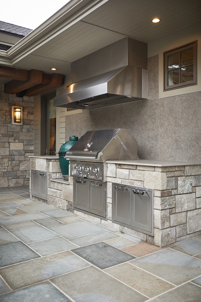 Patio kitchen - traditional backyard stone patio kitchen idea in Grand Rapids with no cover