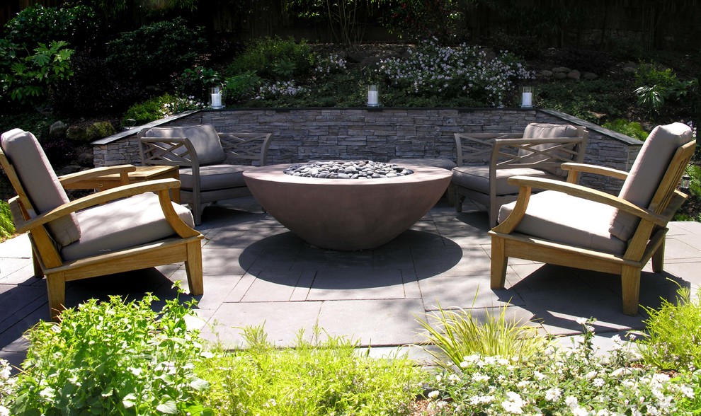 Inspiration for a large rustic back patio in San Francisco with a fire feature, natural stone paving and no cover.