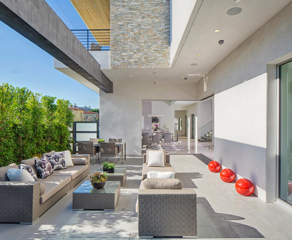 Inspiration for a medium sized contemporary side patio in Los Angeles with no cover and tiled flooring.