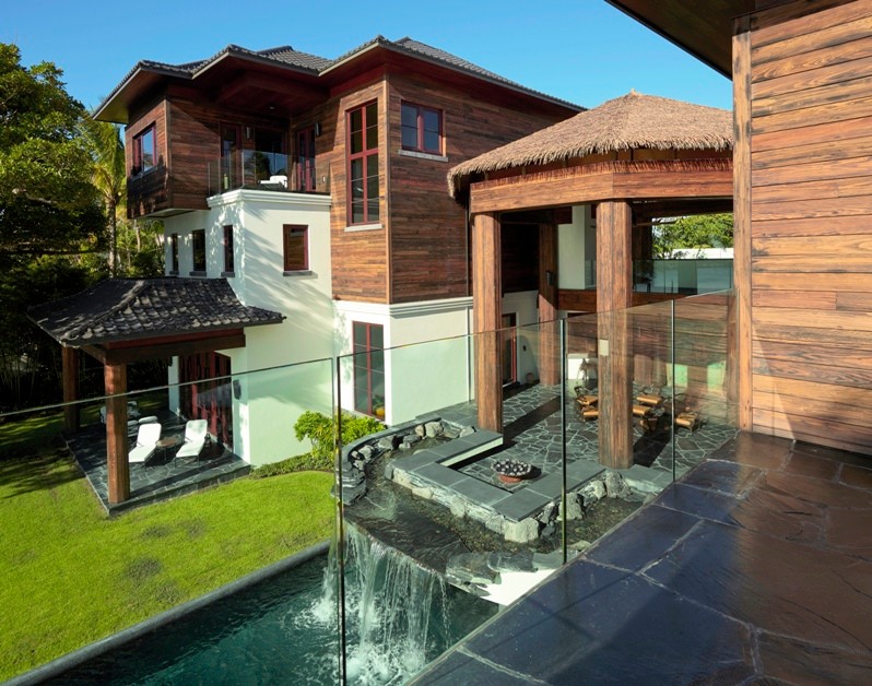 Foto di un ampio patio o portico etnico dietro casa con fontane, pavimentazioni in pietra naturale e un tetto a sbalzo