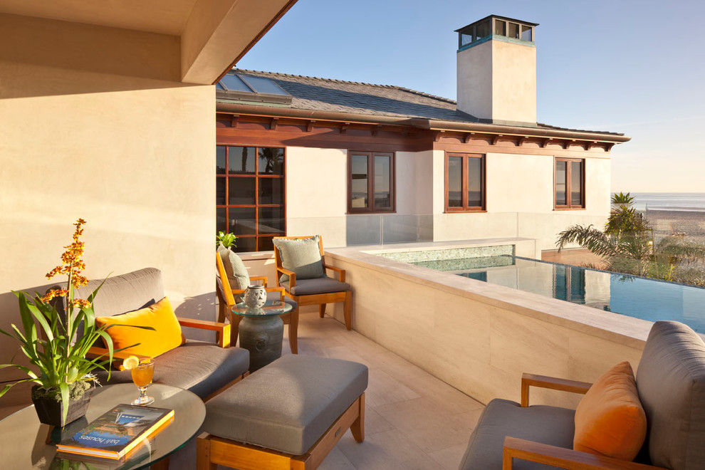 Inspiration for a contemporary patio in Orange County with a roof extension.