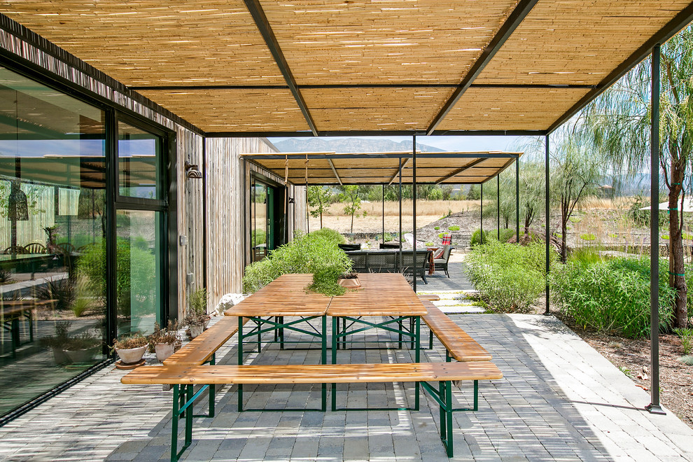 Idées déco pour une terrasse campagne avec des pavés en béton et un gazebo ou pavillon.