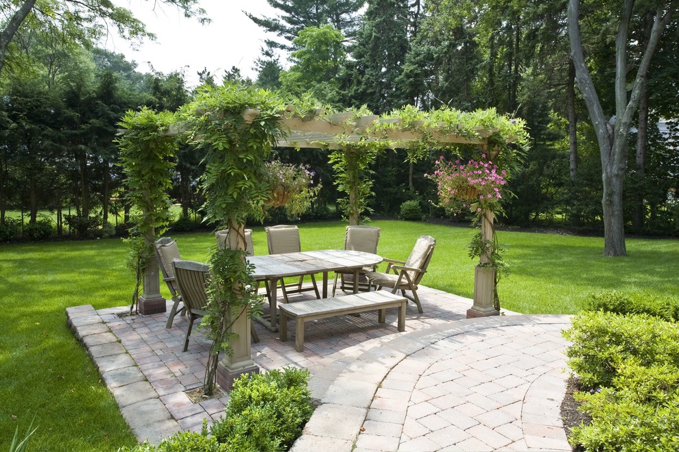 Example of a classic patio design in Boston with a gazebo