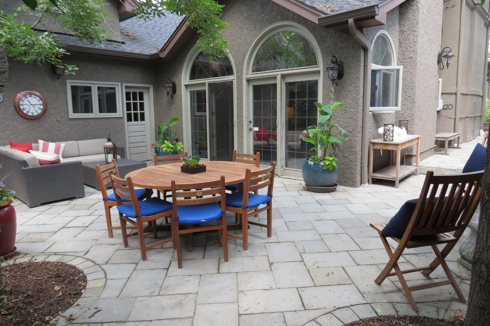 Medium sized mediterranean back patio in Denver with a water feature and natural stone paving.