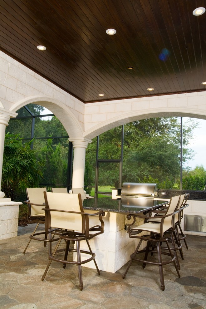 Immagine di un patio o portico chic di medie dimensioni e dietro casa con pavimentazioni in pietra naturale